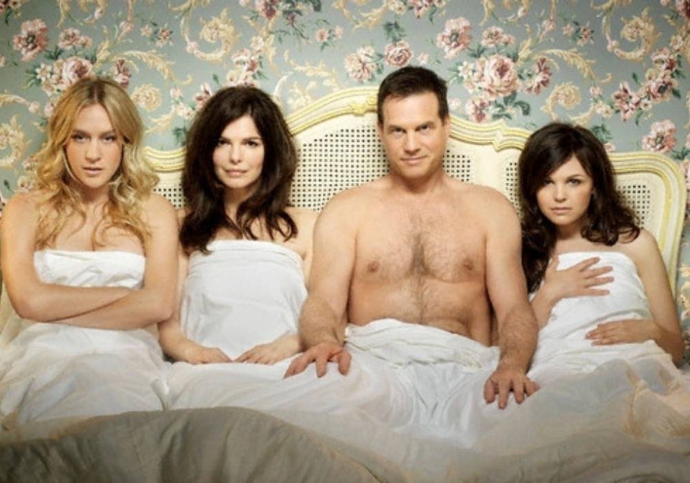 two couples in bed together