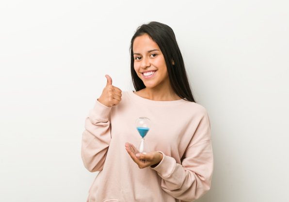 Woman holding hour glass